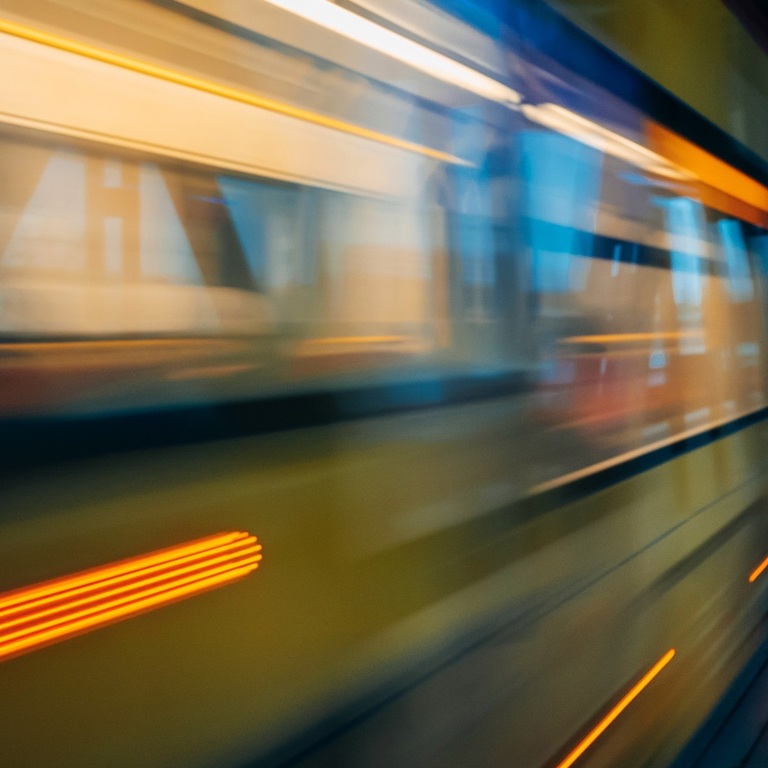 Train travelling through tunnel with lights