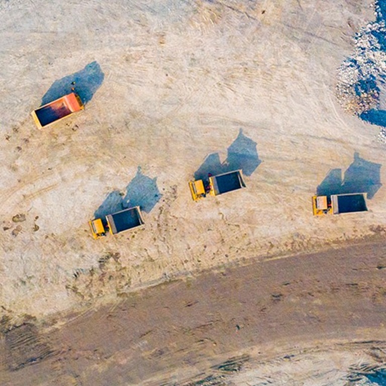 Trucks on a sandy area