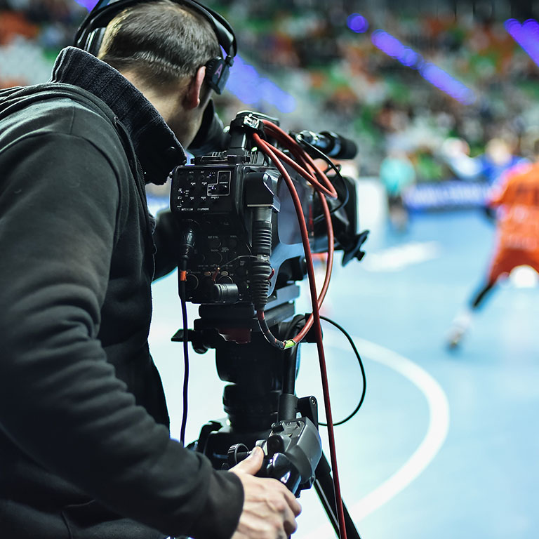TV camera and cameraman during handball match