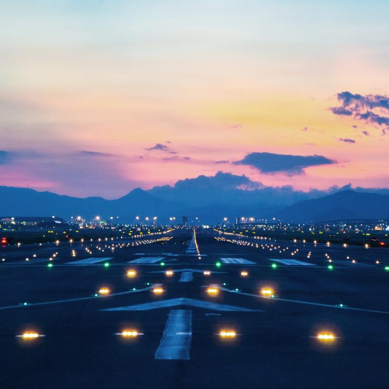 View of the runway with lights at an airport