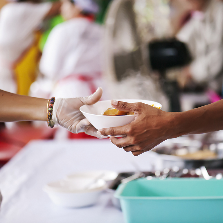 Sharing of food from volunteer hands to homeless person : The concept of feeding