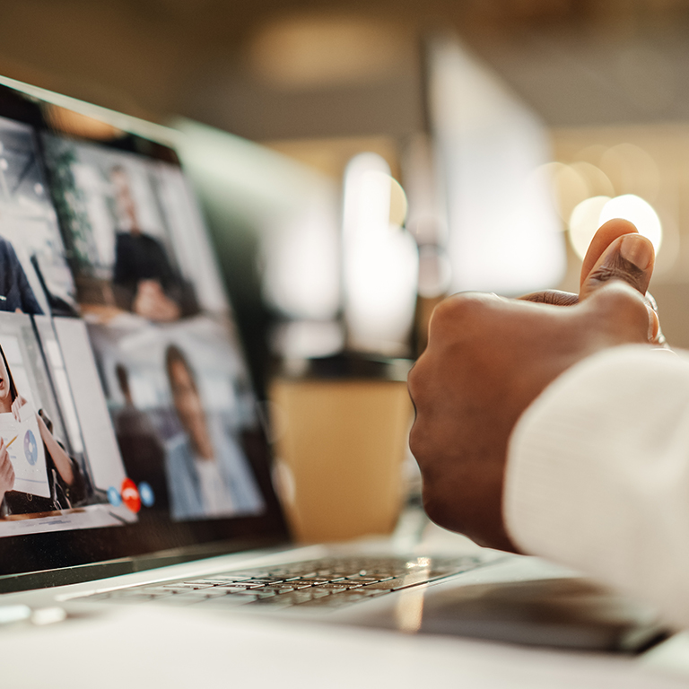 Multiethnic People Conference Meeting Online and Discussing Business Project. Laptop Screen Containing a Group Video Call. Colleagues Working From Home and Collaborating on Internet