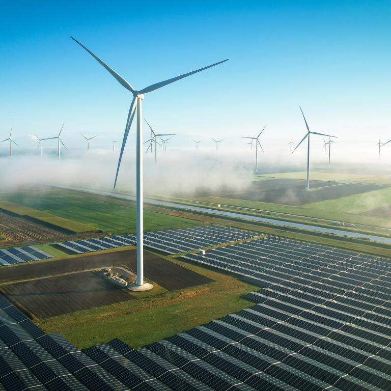 Wind turbines and solar panels on a clear day in the countryside