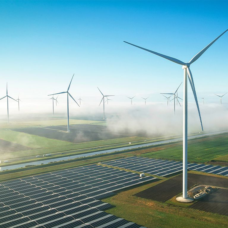 Windmills over green land