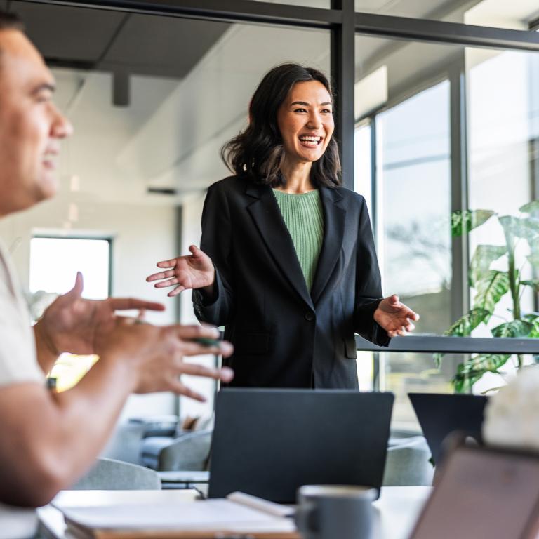 Woman presenting during modern office meeting