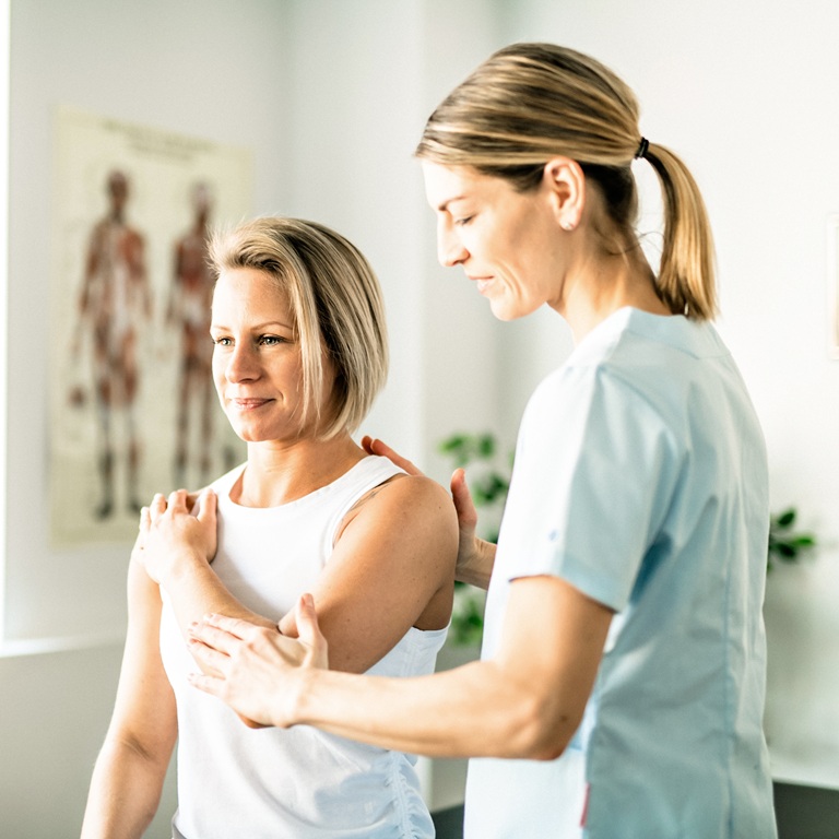 Woman receives shoulder treatment in a clinic setting