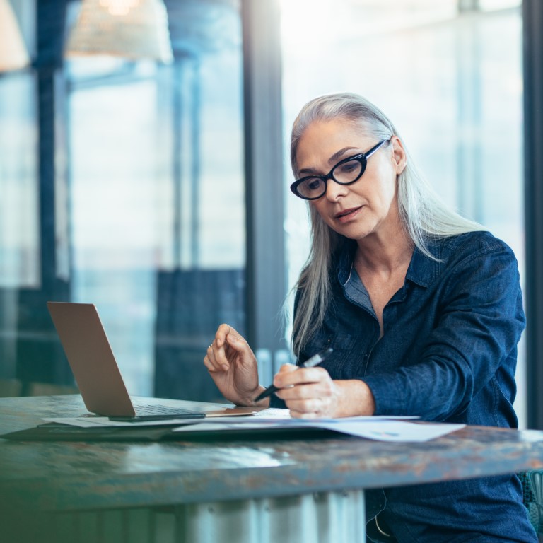 Woman sitting down working on laptop