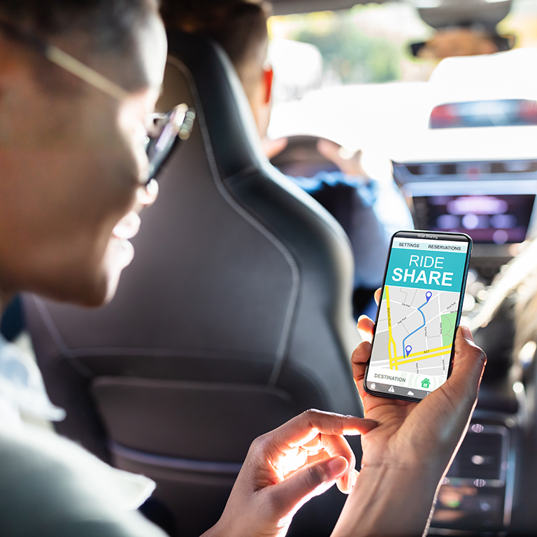 African Woman Using Car Sharing App While Sitting In Car