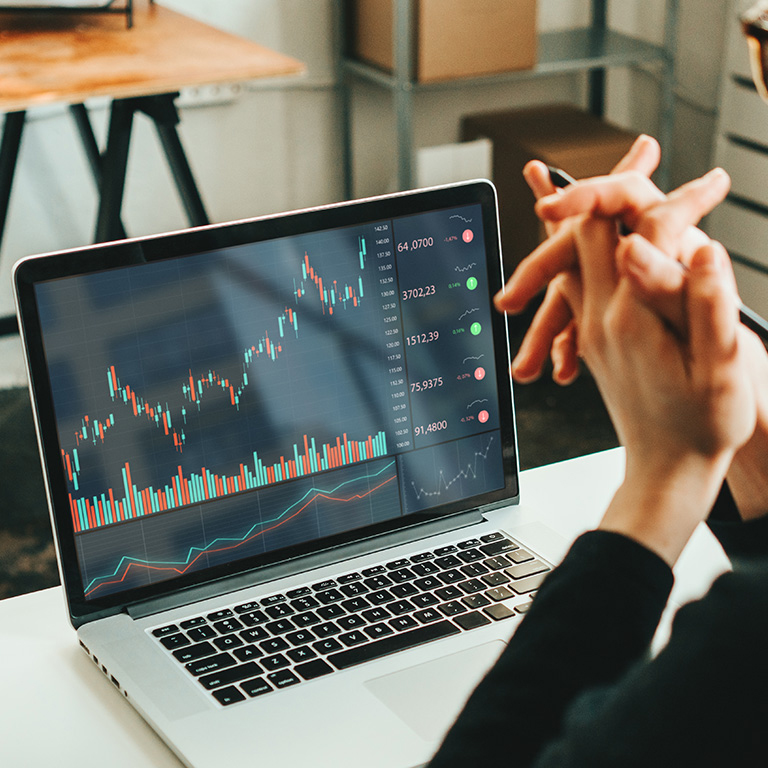 Woman working laptop, analyzing trading data