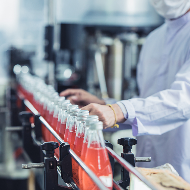 Drink factory - closeup hygiene worker working check juice glass bottled in production line