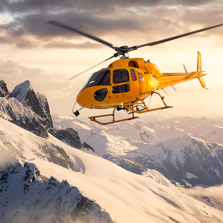 Yellow Helicopter flying over the Rocky Mountains during a sunny and dramatic sunset. Aerial Landscape from British Columbia, Canada near Squamish and Vancouver. Extreme Adventure Composite