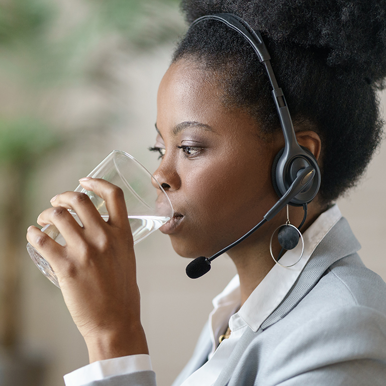 Young black businesswoman in office wearing headset